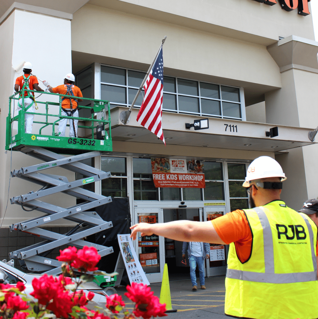 RJB employees on a lift applying a retail coating to a home depot