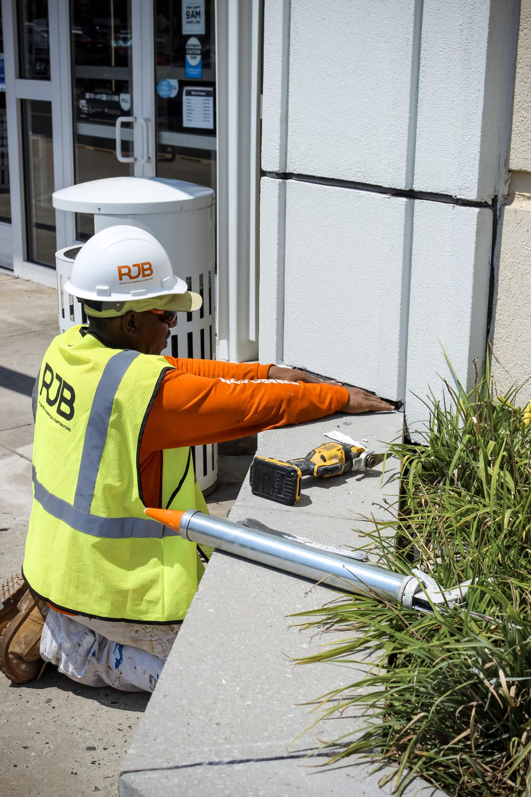 RJB employee working on the exterior of a retail building