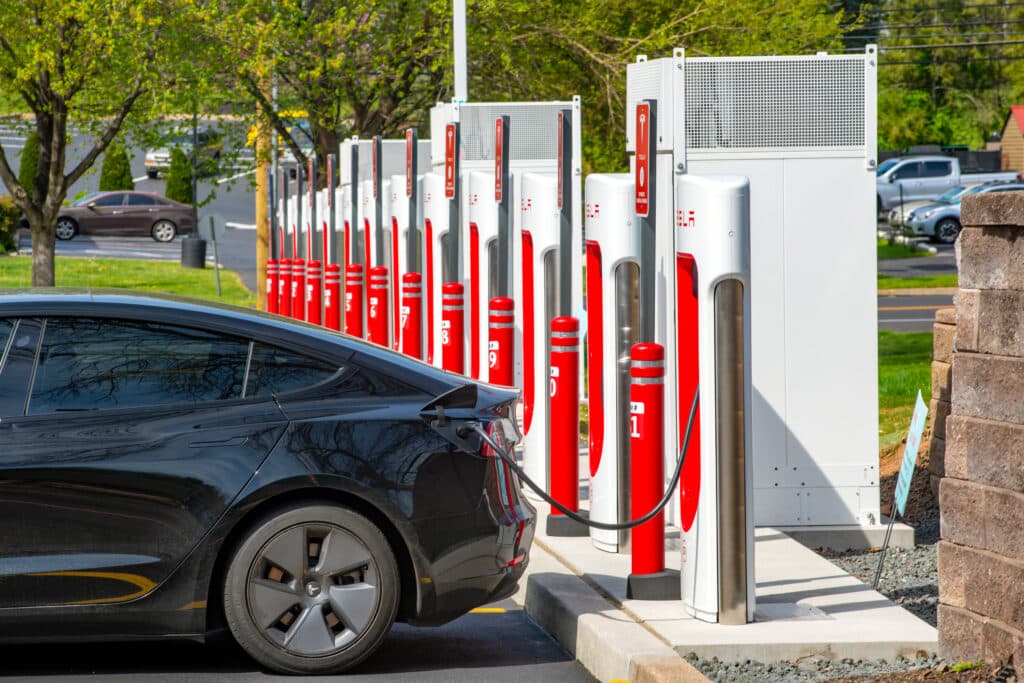 Tesla supercharger installation with car charging