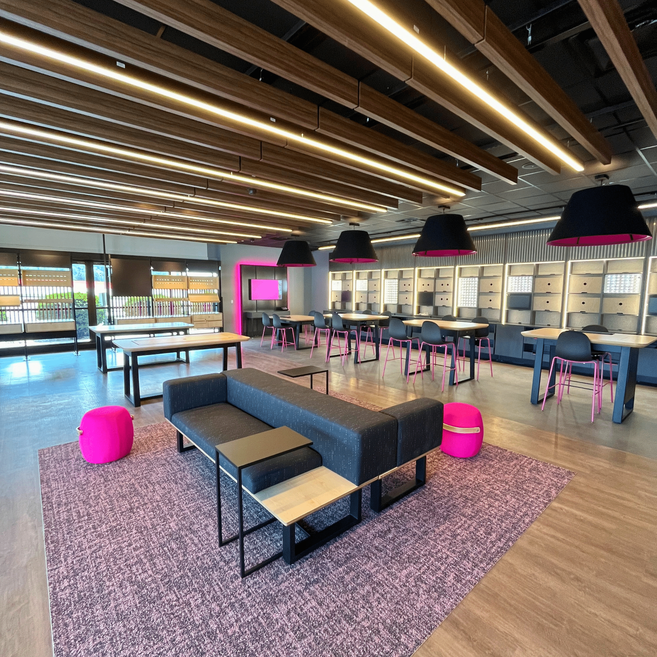 Bright and modern sales area with sleek fixtures, interactive displays, and comfortable seating at the T-Mobile Experiential Store.