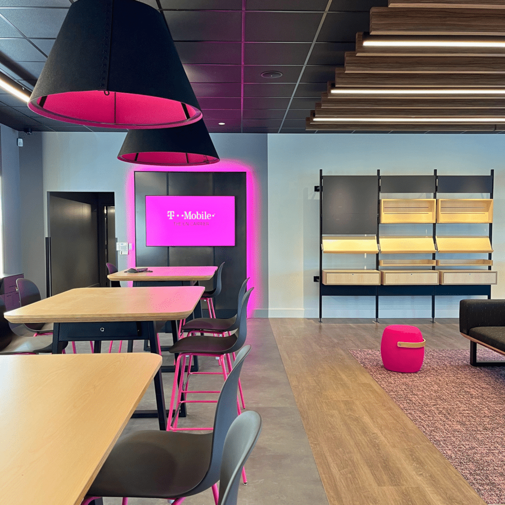 Bright and modern sales area with sleek fixtures, interactive displays, and comfortable seating at the T-Mobile Experiential Store.