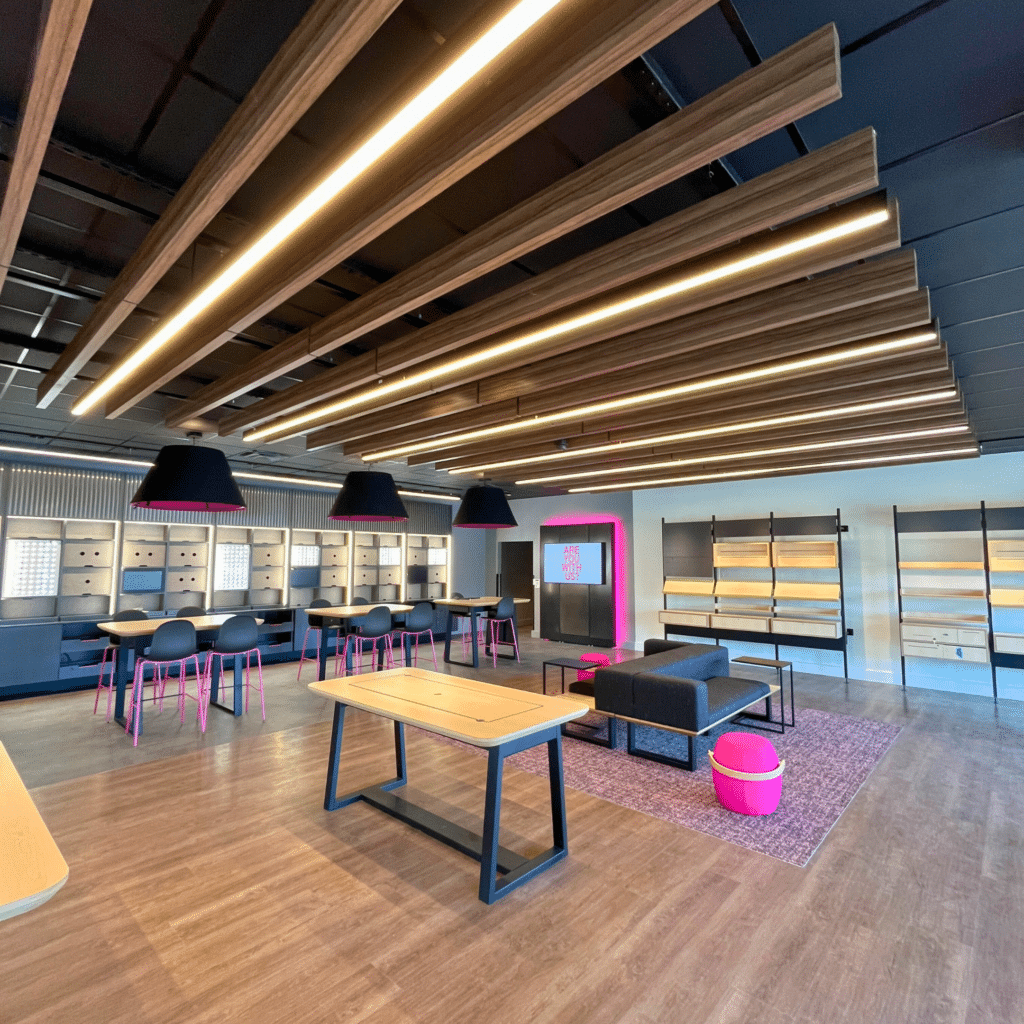 Bright and modern sales area with sleek fixtures, interactive displays, and comfortable seating at the T-Mobile Experiential Store.